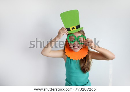 The cute girl in a mask of a leprechaun for a St. Patrick's Day Royalty-Free Stock Photo #790209265