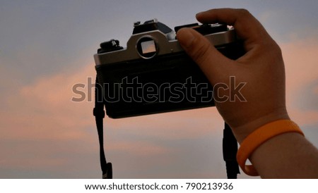 Man hand holding camera