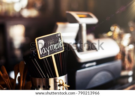 Cashier counter in coffee shop with the word Payment written on the sign