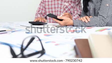 Elderly husband and wife are helping to calculate the monthly miscellaneous expenses within the rental home.