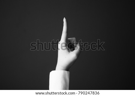 Young Woman's Hand Shows Pointing Finger Gesture.