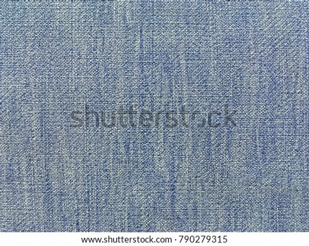 Light blue and white background with pattern, close-up. Structure of the jeans fabric with natural texture. Wallpaper, macro.