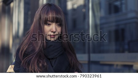 Beautiful Asian women sit in the outdoor cafe
