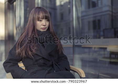 Beautiful Asian women sit in the outdoor cafe