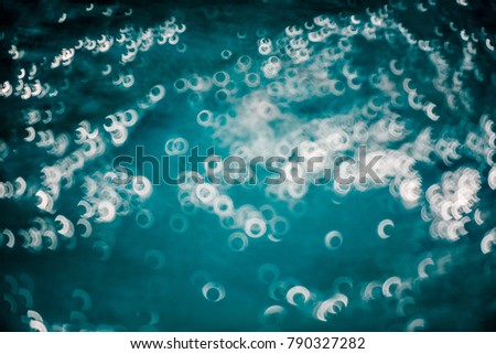 Water and air bubbles over blue background,sea wave ,Bokeh light background in the pool,Hotel swimming pool with sunny reflections.