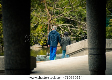 An old couple are taking the walk in park. Royalty-Free Stock Photo #790330114