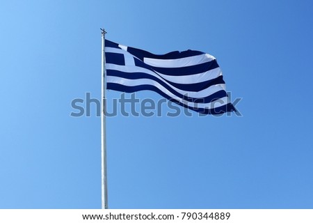 Billowing flag of Greece with a blue sky background