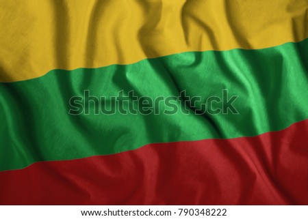 The Lithuanian flag flutters in the wind. Colorful, national flag of Lithuania. Patriotism, a patriotic symbol.