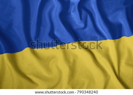The Ukrainian flag is flying in the wind. Colorful, national flag of Ukraine. Patriotism, a patriotic symbol.