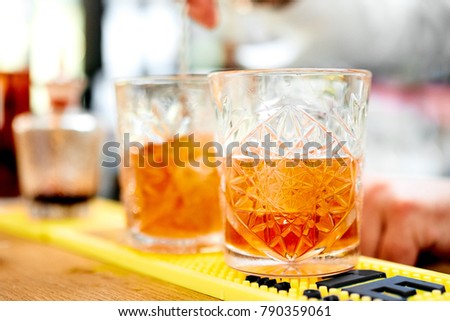 Photo of a cocktails with orange on the bar counter 