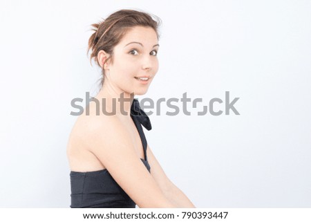 Photo of beautiful young lady standing isolated over white background. Looking camera