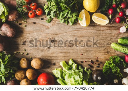 Frame of Fresh Organic Vegetables on wooden background. Top view and copy space for text