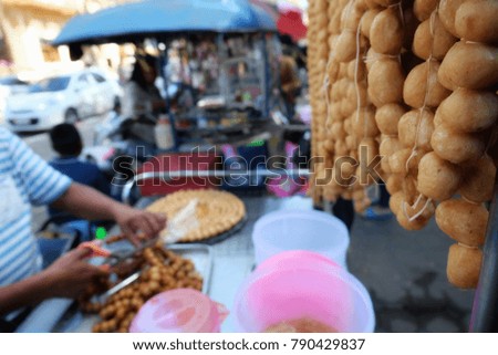 Row of  Thai ball sausage  hanging and preparing for grill and sale on shelf.focus in front row of ball at right picture and blur other point background.Concept Popular street  food in Thailand. 