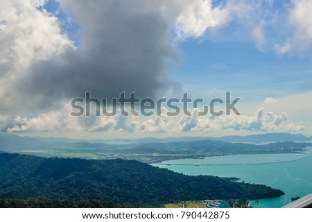 Mighty green mountains with vast blue ocean on one side of Langkawi Island, Malaysia, Asia.