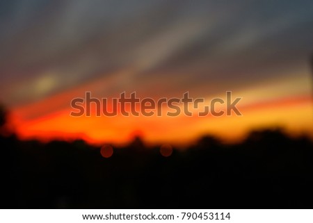 Blurred city background - sunset colors. Natural Sunset Sunrise Over city. Bright Dramatic Sky And Dark Ground.  Landscape Under Scenic Colorful Sky At Sunset Dawn Sunrise. Sun Over Skyline, Horizon. 