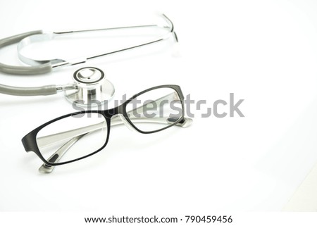 Sunglasses and stethoscope on the white scene. Medical concept