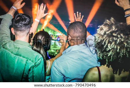 Young people dancing at night club - Hands up on laser show lights at nightclub after party - Nightlife concept with afterparty crowd celebrating dj concert festival event - Vintage contrast filter