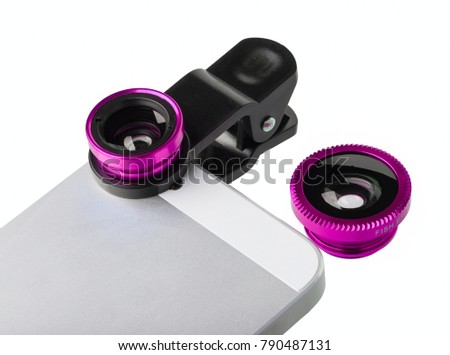 Clip Lens - universal photo lens for mobile phone. Lenses are pink color. One of them is installed to mobile phone, another one lies near
