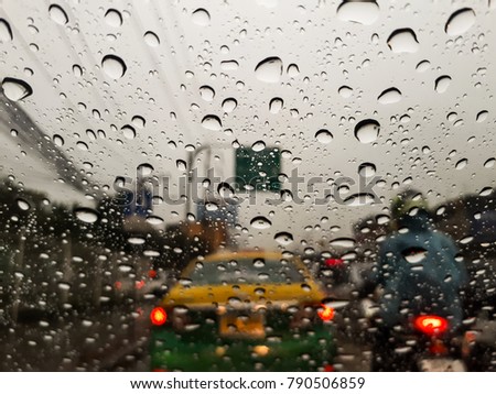 The picture is not clear from the driver's seat in the car, while traffic jams and rain.