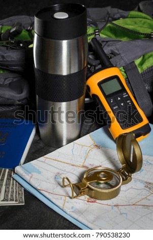 Set for the tourist: backpack, compass, card, walkie-talkie and money
