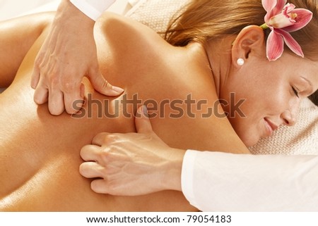 Closeup photo of masseur's hands doing deep tissue massage.?