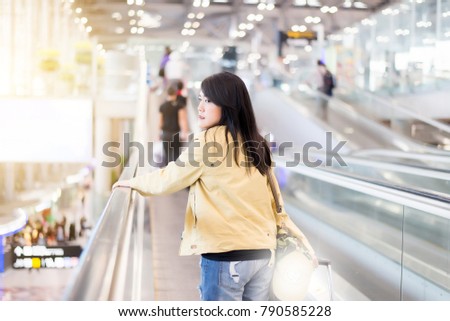 Beautiful asian woman traveling abroad carrying suitcase,luggage,baggage in airport teminal,Travel Vacation Concepts