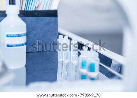 ampoules for injection, standing in a row on the surgical table in the operating room. Professional medical clinic or hospital