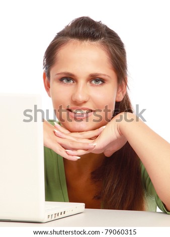 A young college girl sitting in front of a laptop, isolated on white