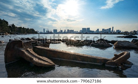 the Tokyo cityscape with a setting sun and anchor over sea