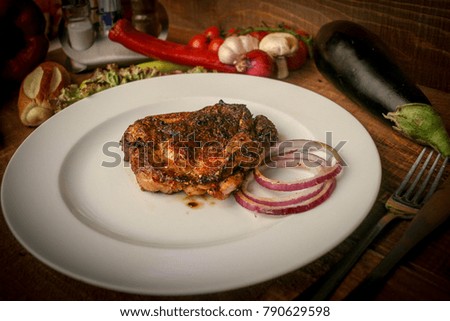 grilled meat, served for the needs of the restaurant. Picture for the menu. Meat with onion
