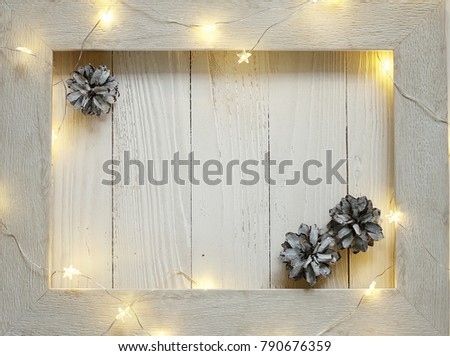 New year background of bright garlands on a wooden light background