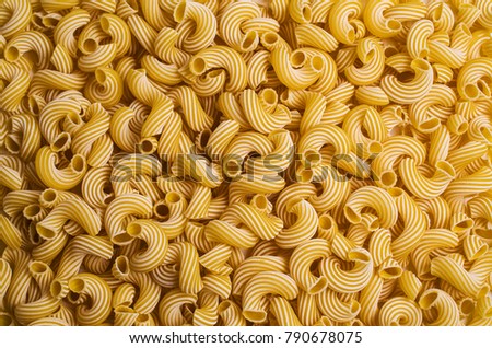 Traditional Italian pasta cavatappi with white stripes. Selective focus.