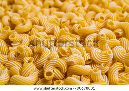 Traditional Italian pasta cavatappi with white stripes. Selective focus.