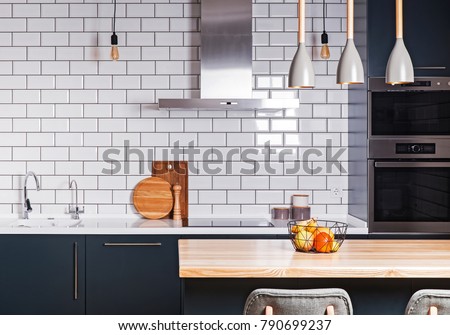 Modern interior. Spacious  kitchen  with white brick tile wall.