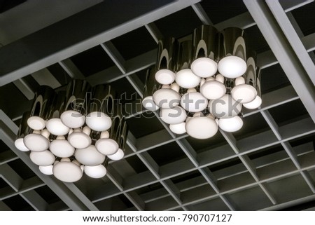 Two modern chandeliers in light shop