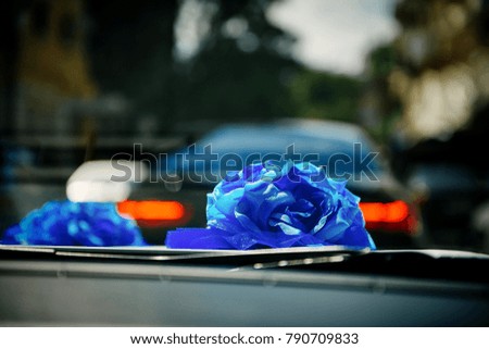 Blue rose on top of wedding car