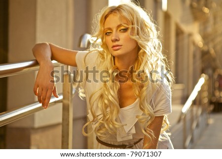 Beautiful blond model outdoor. Street fashion photo.
