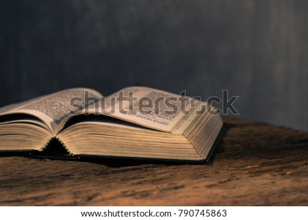 Holy Bible on a old oak wooden table. Beautiful dark background.Religion concept