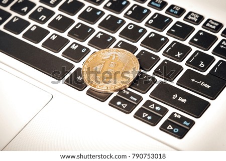 Coin crypto currency bitcoin lies on the keyboard background theme gold exchange pyramid for money due to rise or fall exchange rate close up