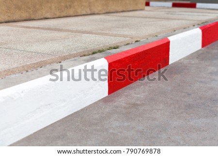 White and red line on the road edge. No parking