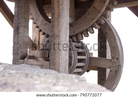 Old wooden cogwheels of winch at the well on the white background