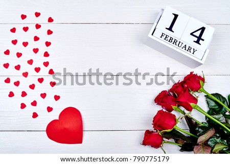 Valentines Day background with bouquet of red roses, hearts and february 14 wooden block calendar, copy space. Greeting card mockup. Love concept. Top view, flat lay