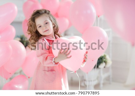 Cute little girl with hearts balloons on valentine's day. family, love. presents on holiday. happiness and kisses