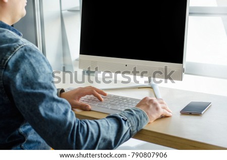 Close up business man view working personal computer sitting wooden table desktop office window skyscraper. Male hands using smart phone typing computer keyboard. Young entrepreneur working  start up