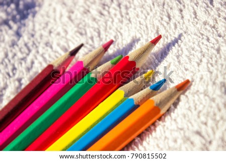 Beautiful bright wooden pencils for drawing on a light background on a sunny day. Copy space.