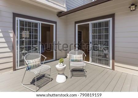 Seating Arrangement on sunny deck showing two sliding doors.