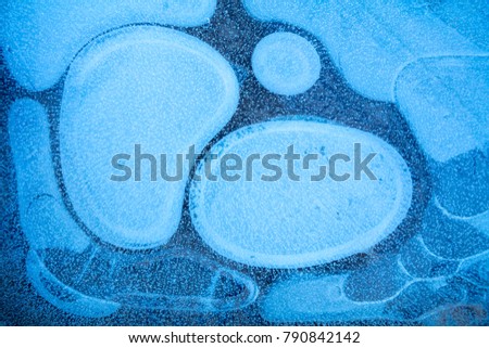 natural abstract pattern on frozen puddle