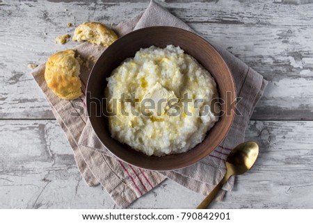 buttered grits with biscuits in rustic setting top view Royalty-Free Stock Photo #790842901
