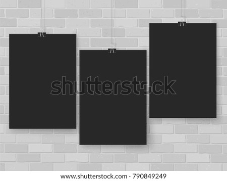 Posters on binder clips on brick wall. Rectangular black paper mock up. Modern vertical framings for your design. Blackboard paper template for lettering, drawing, presentations or quotes.