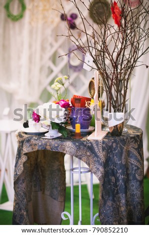 still life in vintage style with flowers, a cup, a teapot, an hourglass, a chess, a book and a deck of cards